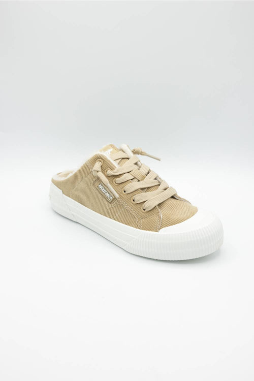 A single low-top slip-on sneaker in beige canvas with a white rubber sole, shown from the side on a light gray background.