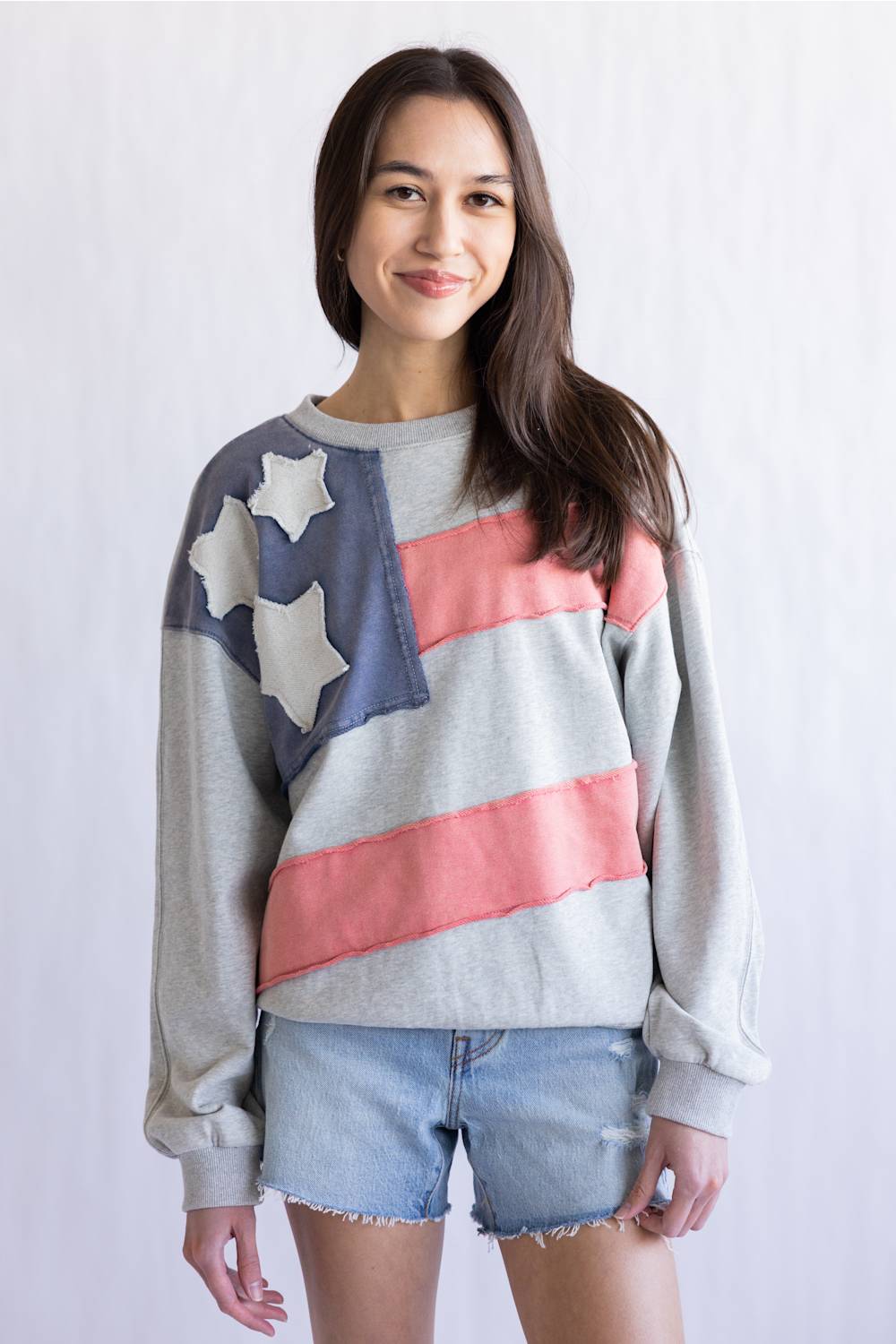 Flag USA Sweatshirt for Women in Grey; Person wearing a sweater with an American flag design on a plain background
