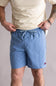 Person wearing blue shorts and a beige shirt against a plain background. The shorts are Quiksilver Saltwater Volley 17" Swim Trunks for Men in Riviera.