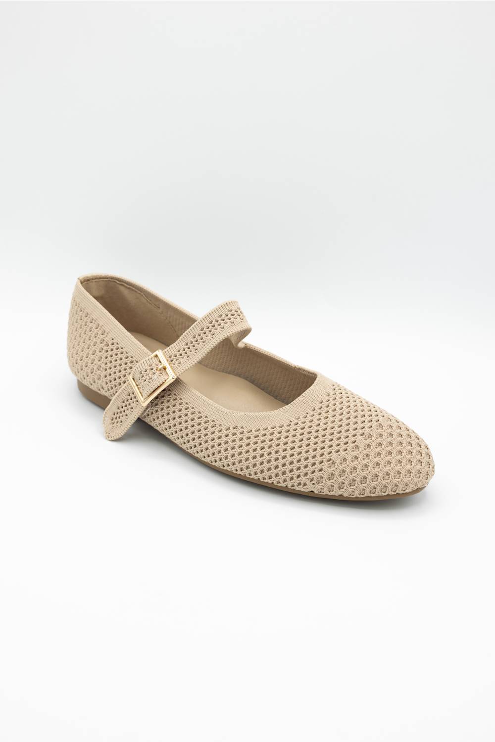 A single beige openwork mesh Mary Jane flat shoe with a gold-tone buckle, shown from a three-quarters angle on a light gray background.
