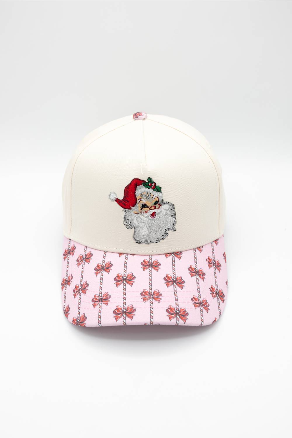 Front view of the Simply Southern Classic Santa Holiday Hat in Cream/Red against a white background, featuring a vintage embroidered Santa patch on the cream front panel and a pink patterned visor decorated with red bows and candy canes.