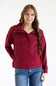 A woman modeling a burgundy half-zip pullover hoodie with a mock neck and front kangaroo pocket, paired with blue jeans, against a plain white studio background.