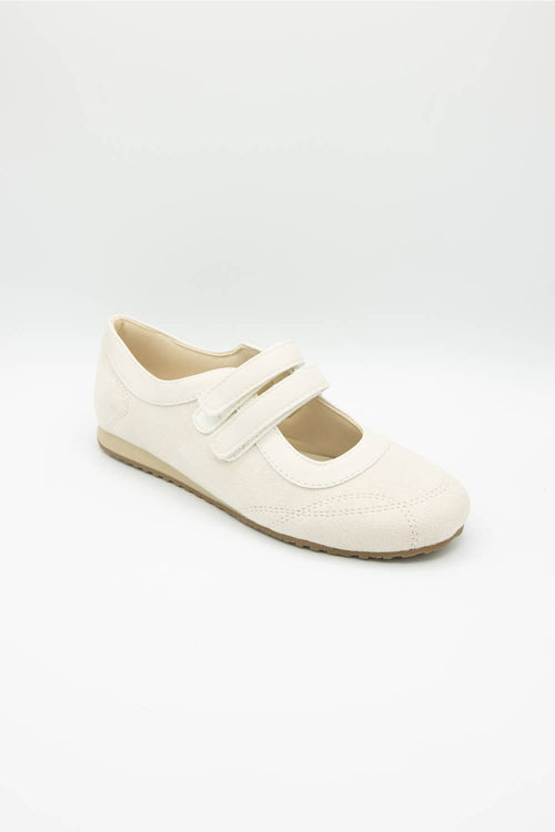White shoe with a velcro straps on a white background