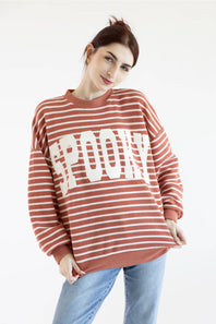 Women wearing dusty mauve sweatshirt with white horizontal stripes, SPOOKY screen printed on front and blue denim jeans on a basic background