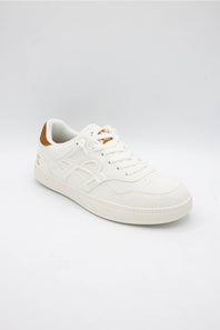 A low-top white leather sneaker with white laces, a white sole, and a small brown accent on the heel tab, shown against a light gray studio background.