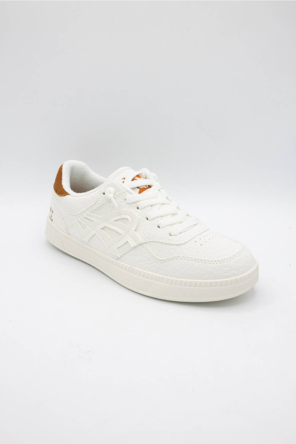 A low-top white leather sneaker with white laces, a white sole, and a small brown accent on the heel tab, shown against a light gray studio background.