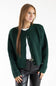 A woman modeling a dark forest green knit cardigan with dark buttons, worn open over a white t-shirt and black faux-leather pants, against a plain white studio background.