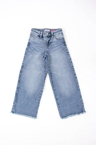 girls jeans laid on a plain white background