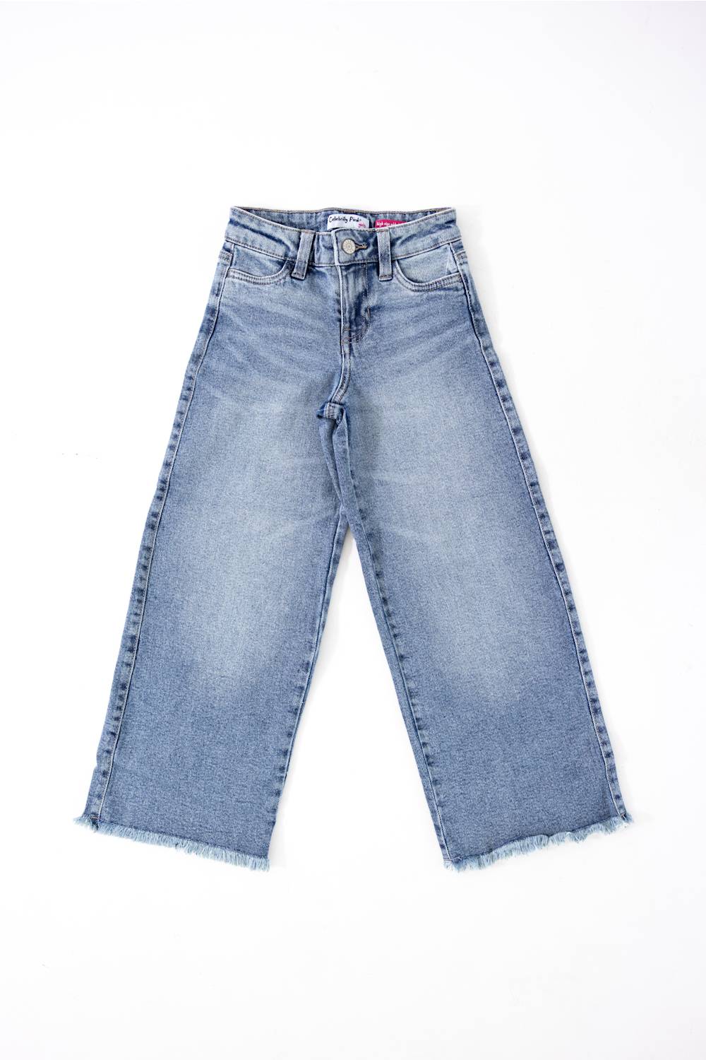 girls jeans laid on a plain white background