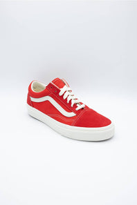 A red suede Vans platform sneaker with white laces, a white side stripe, and a thick white platform sole, photographed on a light gray studio background.