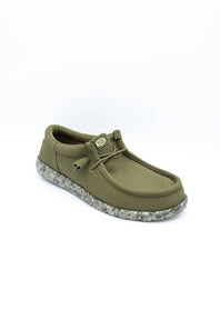An olive green slip-on shoe with a textured fabric upper, matching laces, and a speckled gray and white sole, shown on a plain white background.
