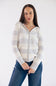 A woman wearing a cream and light gray striped zip-up hoodie with a hood and front pockets, paired with blue jeans, standing against a plain white studio background.