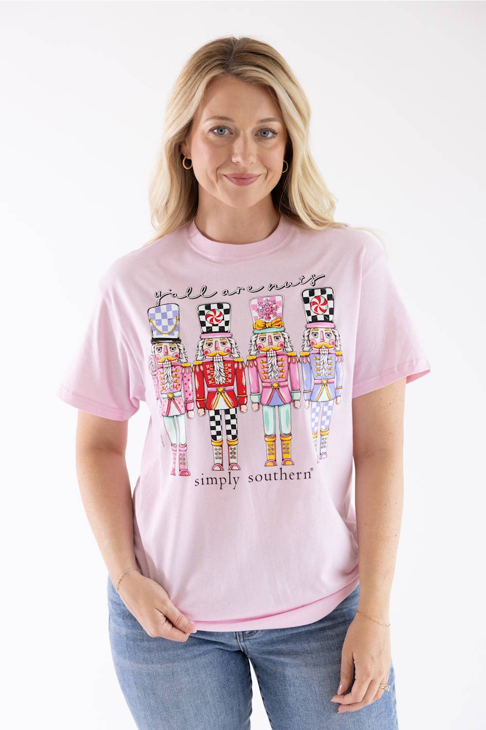Blonde woman modeling a shirt that reads "yall are nuts" with nutcrackers below it 