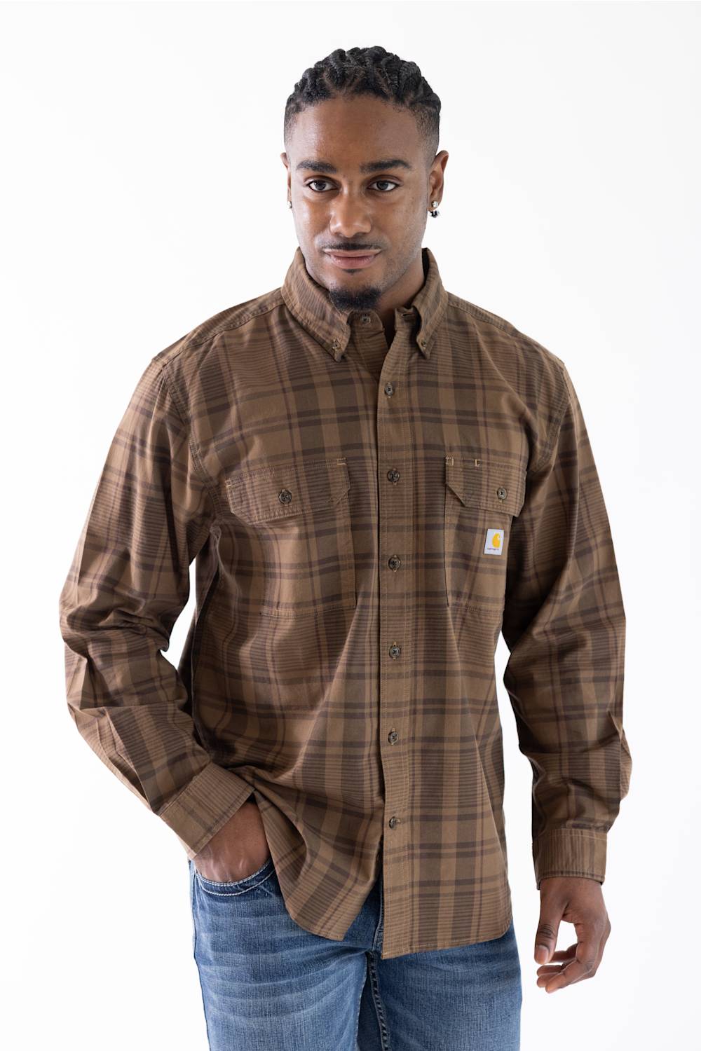 A man wearing a multi-color brown plaid button down shirt