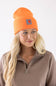 Blonde woman modeling a neon orange Carhartt beanie 
