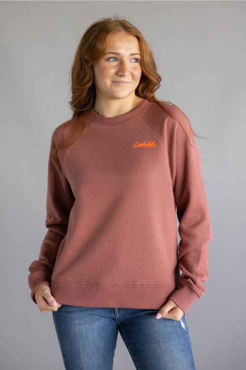 Dark red colored sweatshirt with orange Carhartt cursive letters on chest 