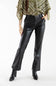 A model wearing black faux-leather flare pants with a matching black belt, paired with a green patterned top and black ankle boots, against a plain white studio background.