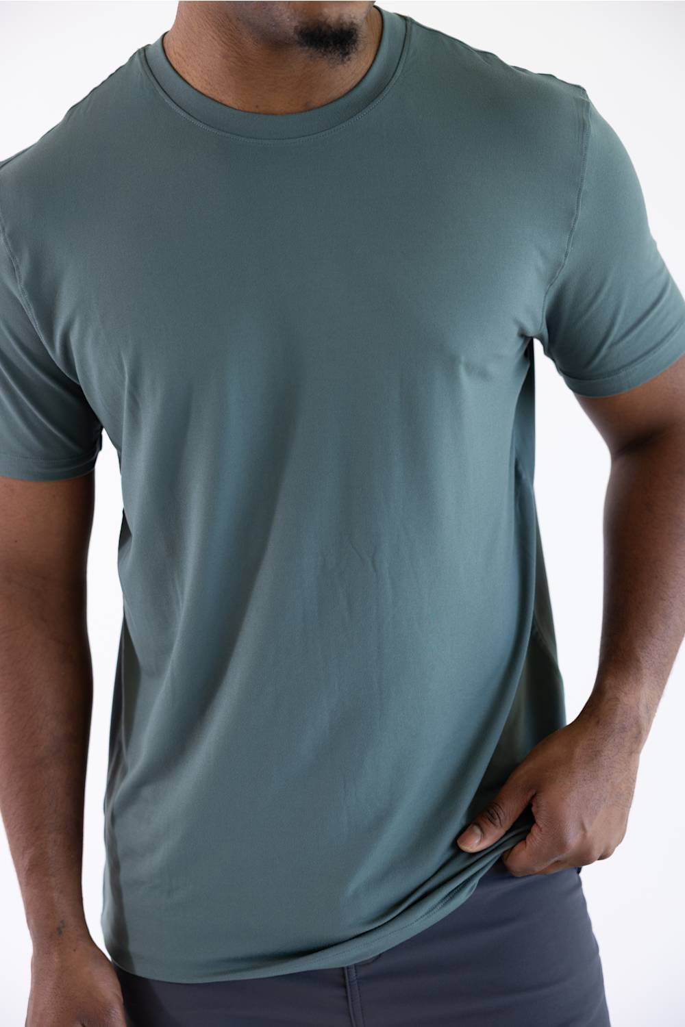 Medium shot of a man wearing the 7Diamonds Core Crew T-Shirt in Drake green, showing the fit across the chest and torso.