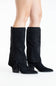 A pair of black suede knee-high boots with block heels, shown on a model's feet against a plain white studio background.