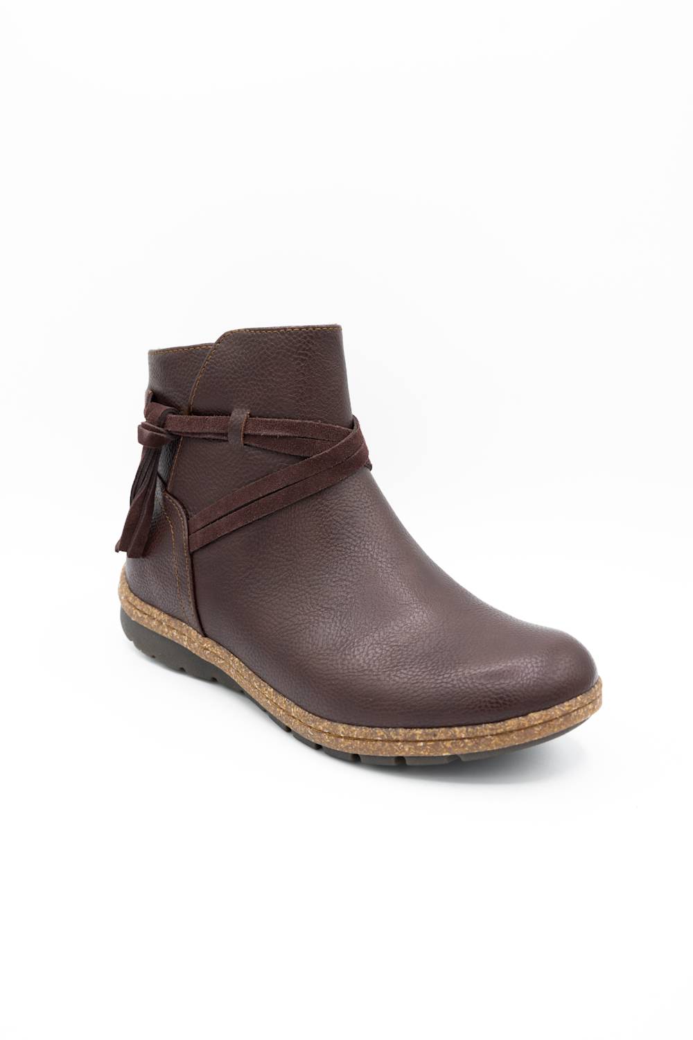 A dark brown leather ankle boot with a textured finish, featuring a decorative side strap with a tassel, a cork-wrapped midsole, and a black outsole, shown against a plain white background.