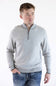 Model wearing an F/X Fusion platinum gray birdseye knit quarter-zip pullover sweater with ribbed cuffs and hem, paired with blue jeans.