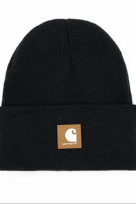 A black ribbed knit beanie hat with a folded cuff, featuring a brown Carhartt brand patch on the front.