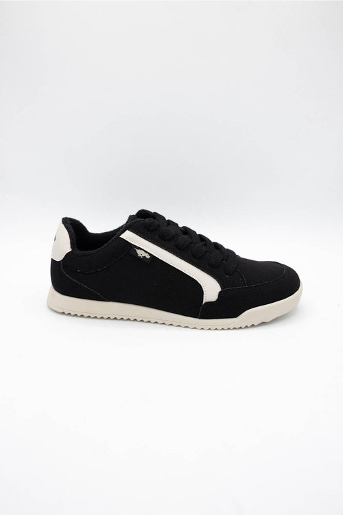 A black low-top sneaker with a white side stripe, black laces, and a white sole, photographed from the side against a plain white background.