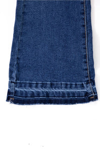 Close-up view of the raw hem line on Celebrity Pink Girls Braided Waistband Flare Jeans in Nancy medium wash