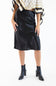 A model wearing a black satin midi skirt with a side slit, paired with a patterned top and black ankle boots, against a plain white background.