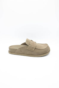 A single taupe suede slip-on clog shoe with a thick sole, shown from a side profile view against a plain white background.