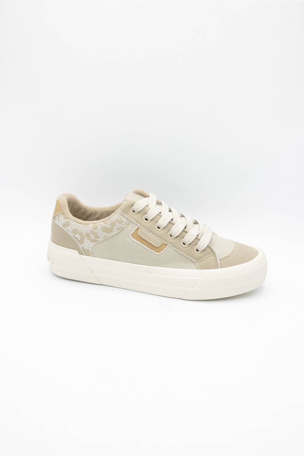 A low-top sneaker in beige and off-white, featuring a patterned fabric on the heel, white laces, and a thick white rubber sole, shown against a plain white background.