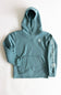 A teal blue-green Carhartt pullover hoodie laid flat on a light off-white background. The hoodie features a small white Carhartt logo on the left chest and a large white vertical Carhartt logo printed down the right sleeve.