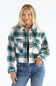 A woman modeling a cropped long-sleeve plaid flannel jacket in green, white, and gray, paired with blue jeans against a plain white background.
