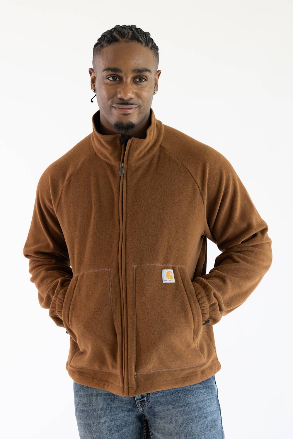 Front three-quarter view of a man wearing the Carhartt Elkhart fleece jacket in Red Duck brown, featuring a mock neck collar, full front zipper, lower patch pockets with the Carhartt logo, and elastic sleeve cuffs.
