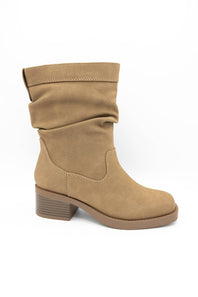 A tan suede slouch ankle boot with a low block heel, shown from a side profile on a white background.