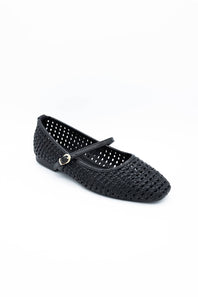 Image of a singular woven flat with a  strap across the ankle 