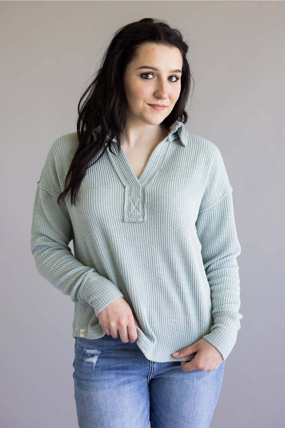 Ribbed v-neck sweater with long sleeves and exposed seams in light teal