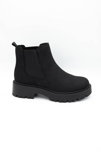 A single black Chelsea-style ankle boot with a chunky lug sole, shown in a side profile on a plain white background.