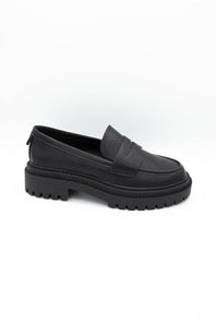 Black dress shoes with textured details on a white background
