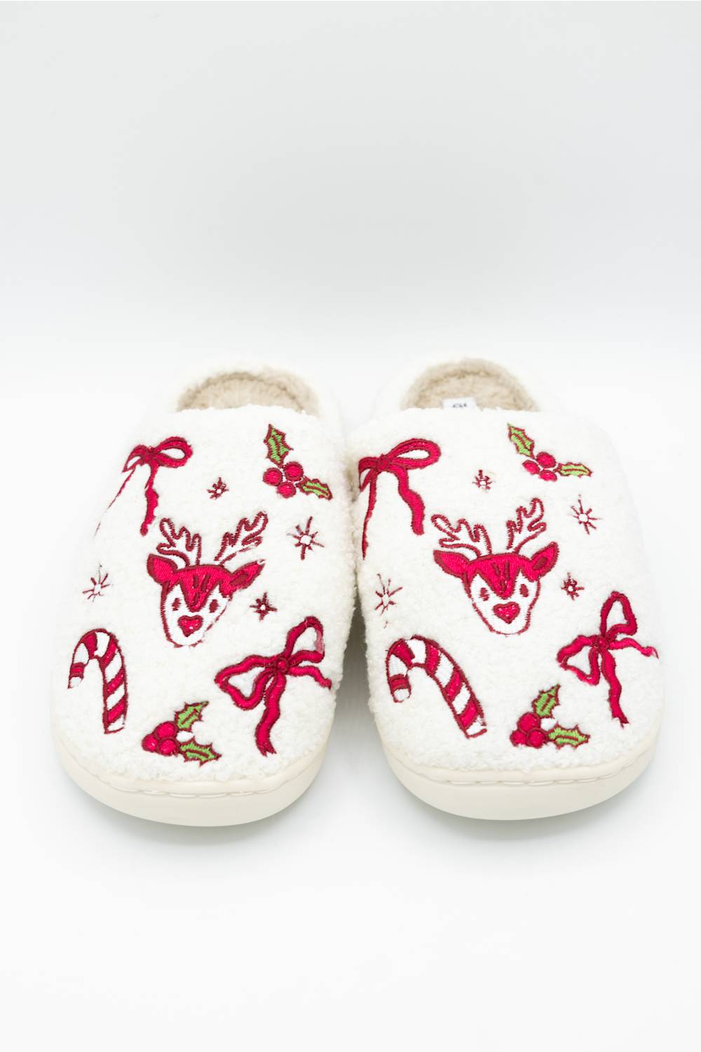 slipper close ups of the reindeer, bow, candy cane, and other holiday motif designs on the top 