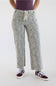 High-waisted wide-leg cropped jeans in a light grey leopard print, featuring a drawstring waist, raw hem, and styled with a dark top and sneakers.