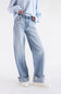 A person wearing light-wash blue wide-leg jeans with rolled cuffs, paired with a blue-and-white striped long-sleeve top and white sneakers, photographed against a clean white studio background.