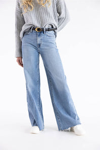 Flying Monkey high-rise medium wash wide-leg denim jeans modeled with a cropped grey sweater and white sneakers