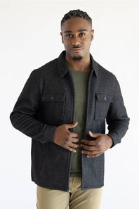 A man wearing a Hallstatt full zip Knit Jacket for Men in Charcoal Grey with two chest pockets.