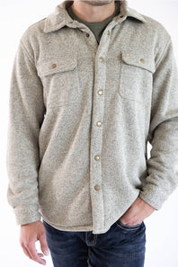 A close up of a man wearing a snap up Hallstatt Sherpa Lined Shacket for Men in Oatmeal Heather with two chest pockets.