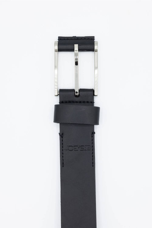 A black leather belt strap with a polished silver-tone metal buckle, shown vertically against a plain white background. The brand name JOE'S is debossed on the loop.