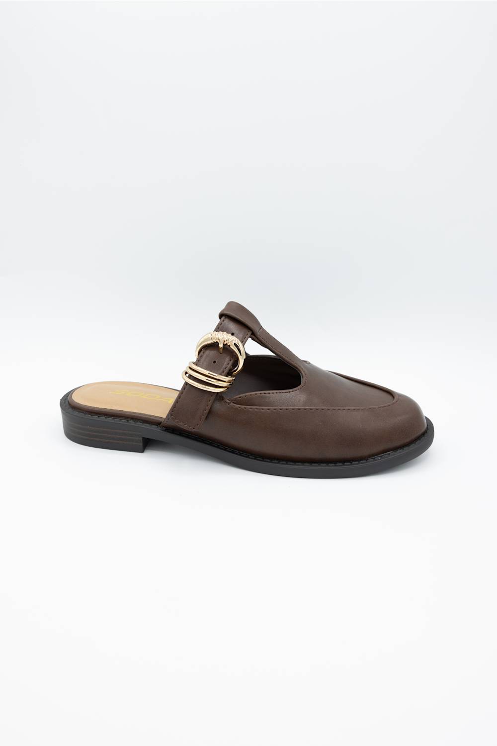 A dark brown leather mule sandal with a low black heel and a gold-tone buckle detail on the strap, shown from a side profile against a light gray background.