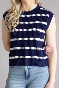 A close-up view of a woman wearing the back of the La Miel Crochet Stripe Top for Women in Galaxy, a striped sleeves knit sweater in navy and white