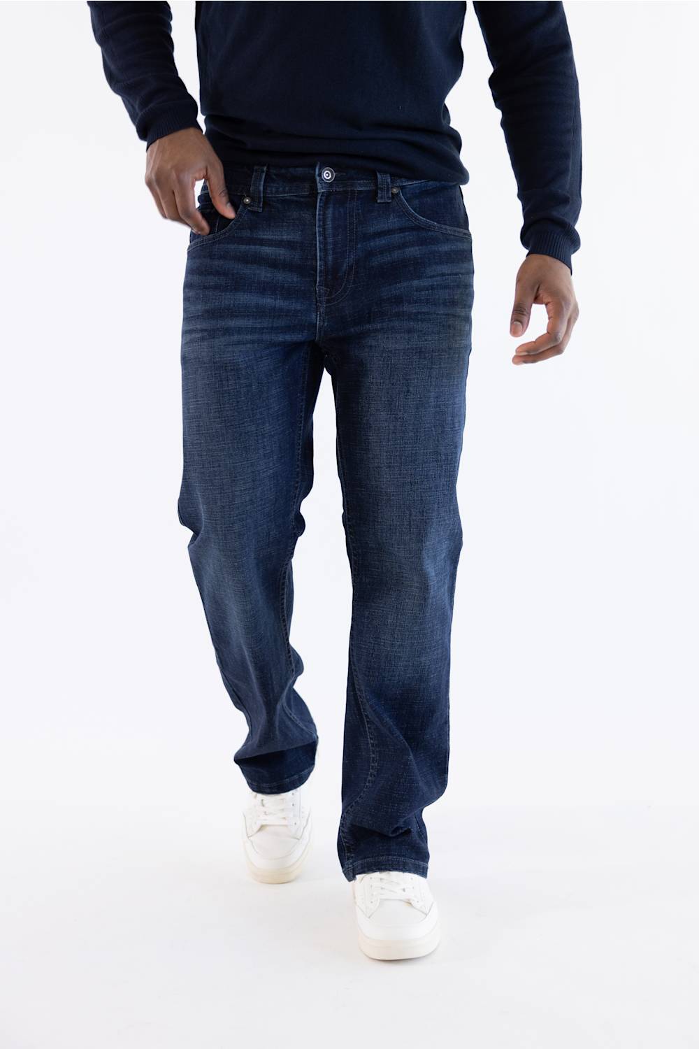 Front view from chest down of a person wearing Axel Jeans Landon Bondi Wash bootcut jeans with a dark navy long-sleeve shirt and white sneakers