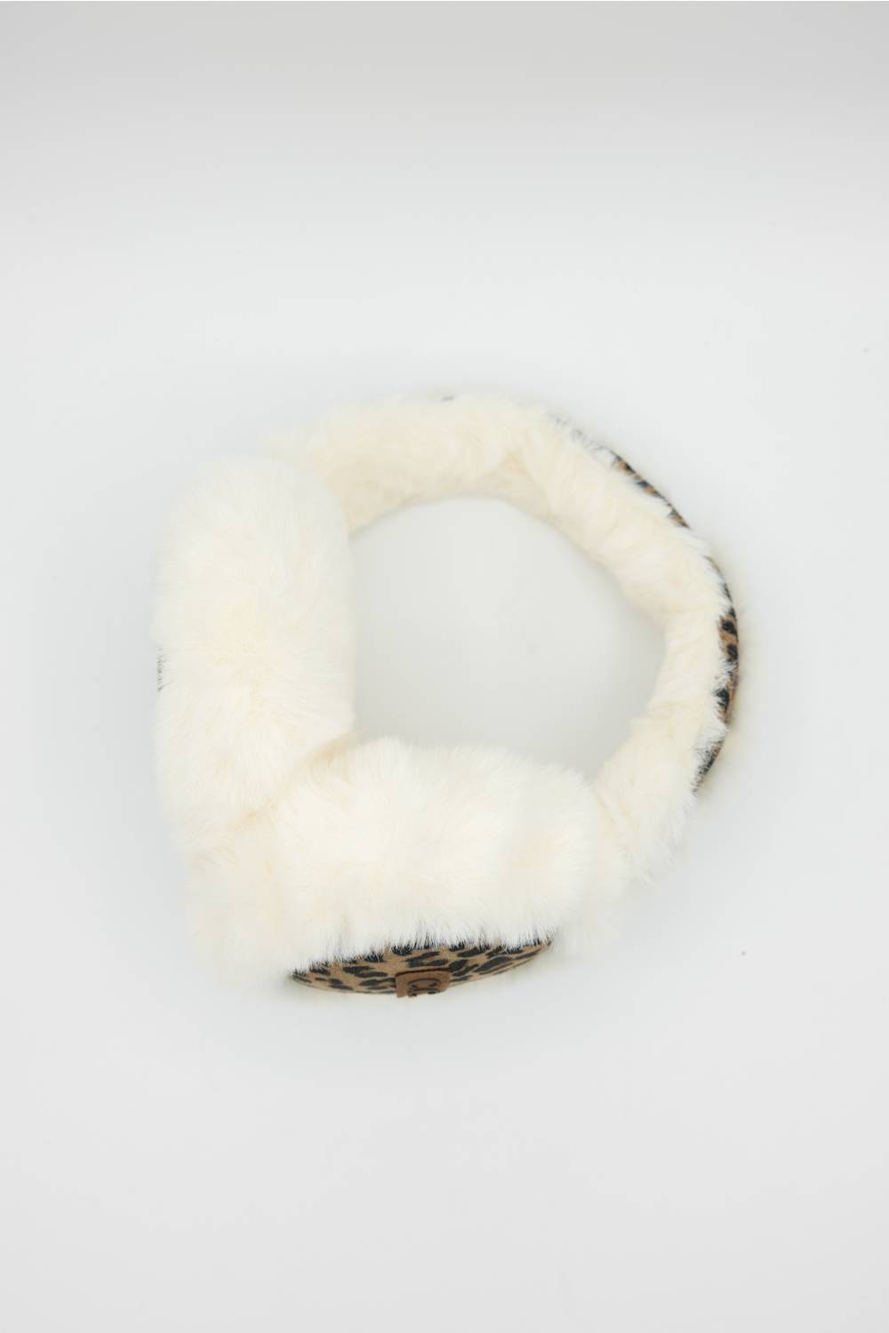 White faux fur earmuffs with a leopard print inner lining, shown on a plain white background.